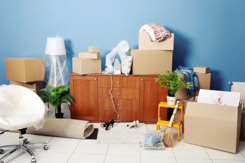 Professional movers loading a van with household items in Highbury